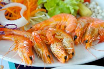 Tiger shrimp prawns with fresh lettuce in plate