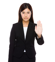 Serious businesswoman with hand show with stop gesture