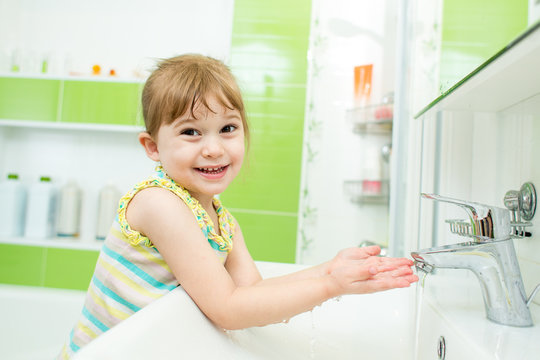 kid girl washing in bathroom