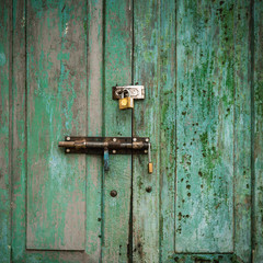 grunge door green double lock and background.