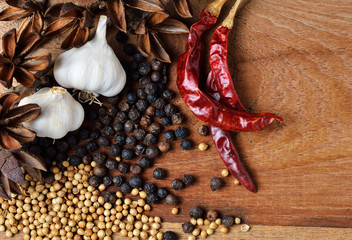 Pepper and dried Chilli on wooden board