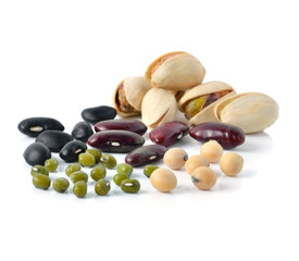 assortment of tasty nuts with leaves, isolated on white