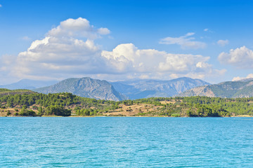 View of the coast and the mountains from the water side.