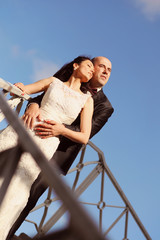 Romantic bride and groom on a bridge