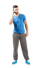 Fototapeta premium Sporty athlete on the phone looking away