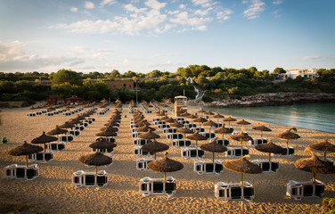 Fototapeta premium Beach umbrellas at sunset