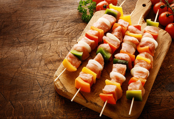 Tasty uncooked meat kebabs in a country kitchen