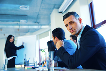 Businesspeople sitting on the meeting while businesswoman