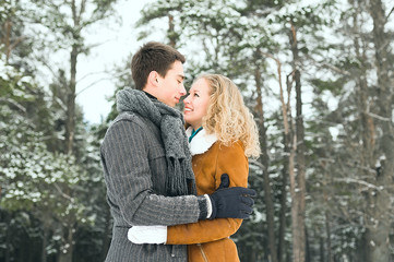 Fototapeta premium Happy Young Couple in Winter Park having fun