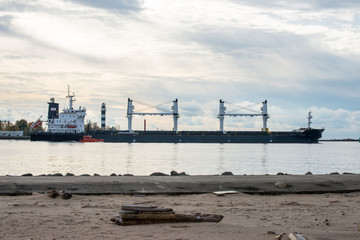 cargo ship is leaving port sailing away