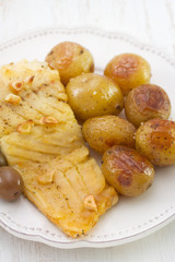 fish with potato on white plate