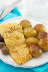 cod fish with potato on white plate