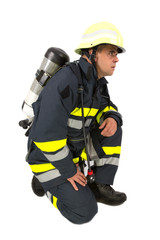 Fototapeta premium Fireman in uniform isolated in white