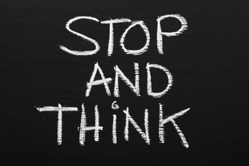 The phrase Stop and Think written on a blackboard