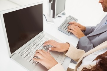 Hands using computers in office