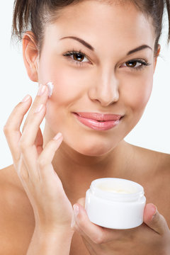 Flawless-skinned woman with moisturizing face cream