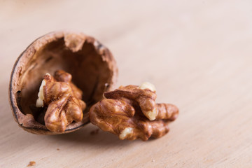 Walnut kernels on wooden background with copy space
