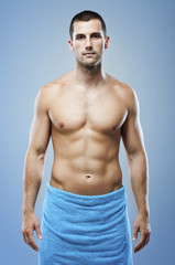 Fototapeta premium Young muscular man in bathroom