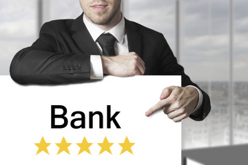 businessman pointing on sign bank