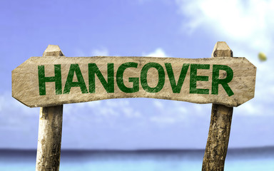 Hangover wooden sign with a beach on background