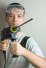 Teen with a drill in his hands