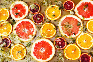 Ripe red oranges and grapefruits cut by rings