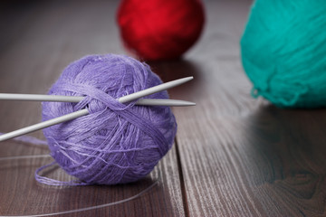 knitting needles and balls of threads