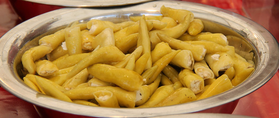 A Metal Bowl of Prepared Yellow Chilli Peppers.