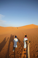 Fototapeta na wymiar Camel ride through the desert of Merzouga