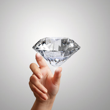 hand holding 3d diamond over white background