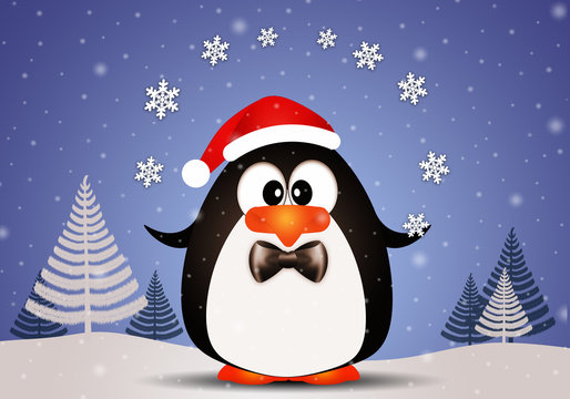 Funny penguin playing with snowflakes