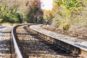 Train tracks disappearing in the distance in autumn landscape