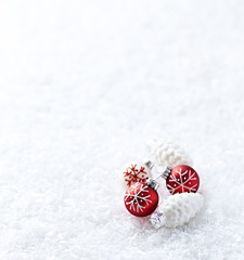 White and red christmas balls on white snow