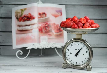 Fototapeten Kitchen Scale weighing strawberries and food magazine recipe © stickasa