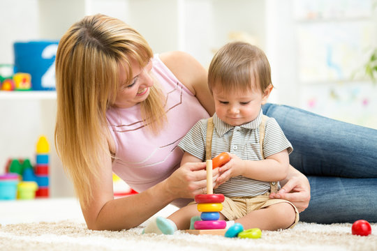 happy mother and child son play together indoor at home