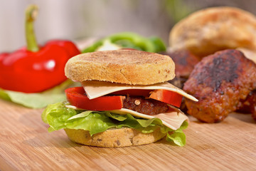 Homemade cheeseburger with a fresh lettuce and red pepper