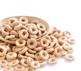 Wooden spoon with cereal rings on white background