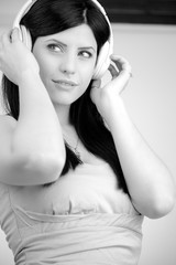 Black and white portrait of beautiful woman listening music