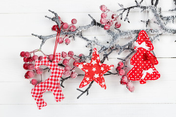 Figures deer, stars and Christmas tree on a branch with berries