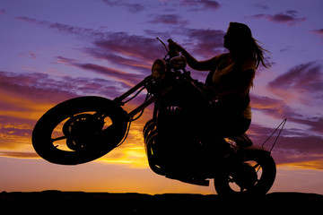 Fototapeta na wymiar silhouette woman sit on motorcycle hair blow