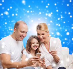 happy family with smartphones