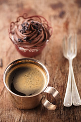coffee and cupcake in rustic style on wooden table