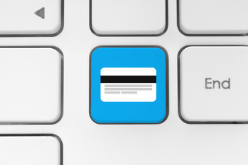 Blue button with credit card on the keyboard close-up.
