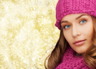 close up of smiling young woman in winter clothes