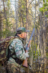 Fototapeta premium Hunter stalks the bird in the forest