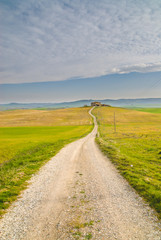 Road to house between fields in Tuscany, Italy.