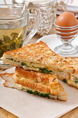Warm toast with cheese and spinach for breakfast
