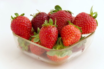 Red ripe strawberry in vessel at white background