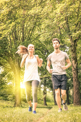 Happy couple jogging in the park - Love and fitness together