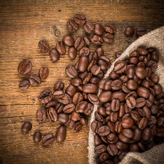 Coffee beans on grunge wooden background